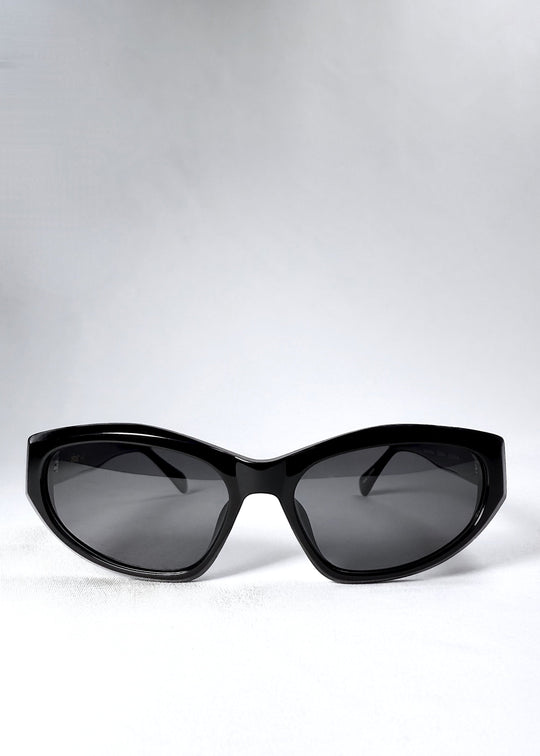  Front view of Void Striker in Obsidian Black showing symmetrical angular cat-eye silhouette with polarized grey lenses. 