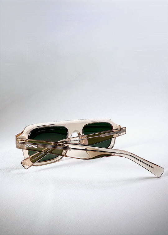 Dynamic view of Vortex Edge - Champagne Glow sunglasses reflecting light on the transparent beige acetate. 
