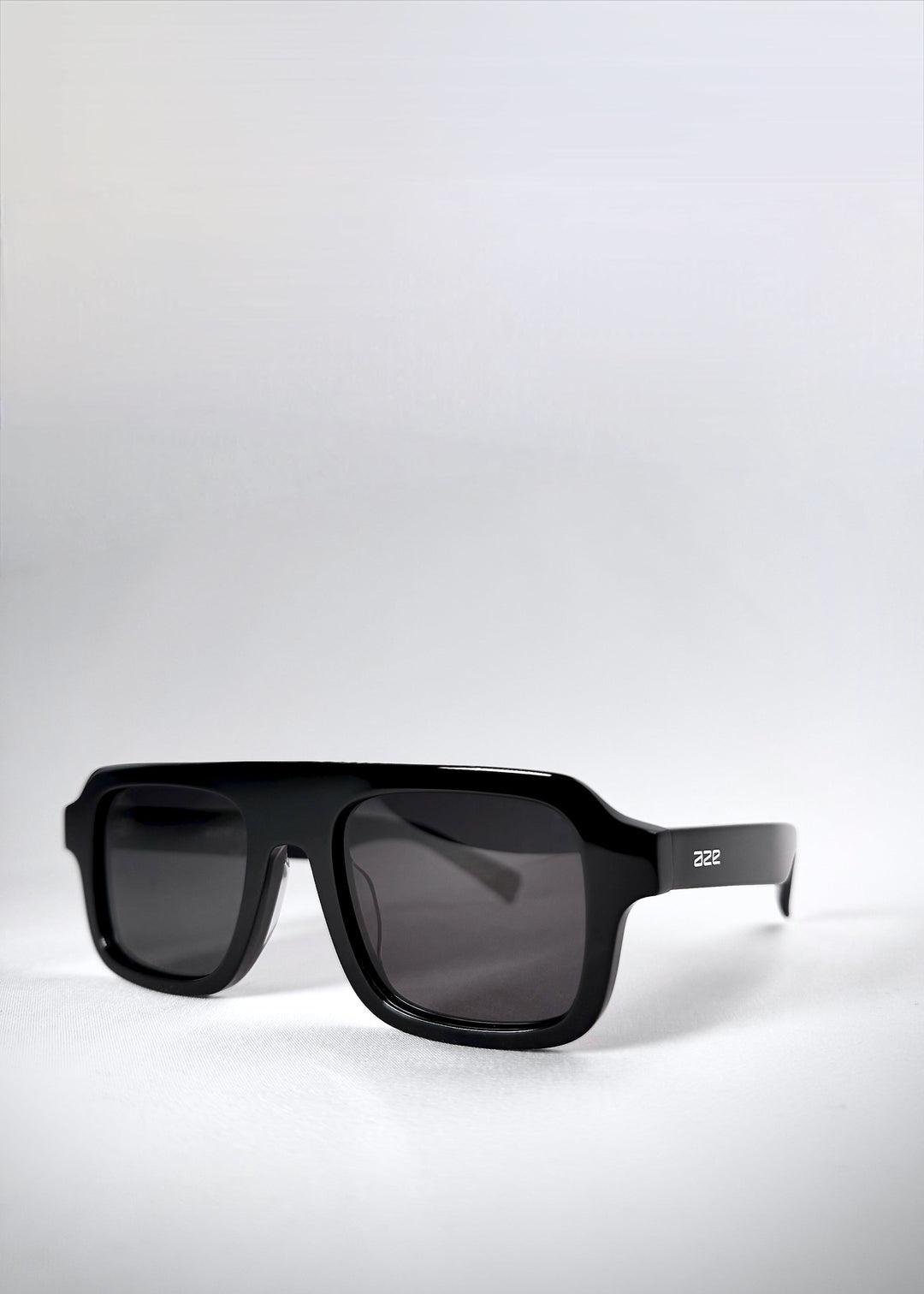 Three-quarter angled shot of Vortex Edge sunglasses in Obsidian Black, showing the geometric frame and dark polarized lenses. 
