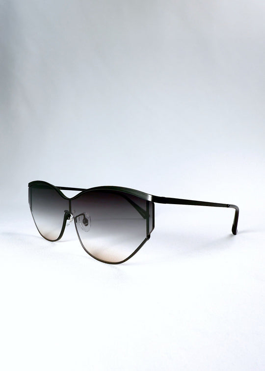 Three-quarter front view of Zenith sunglasses in Midnight Eclipse, highlighting the curved frame and charcoal-to-tea lens gradient. 