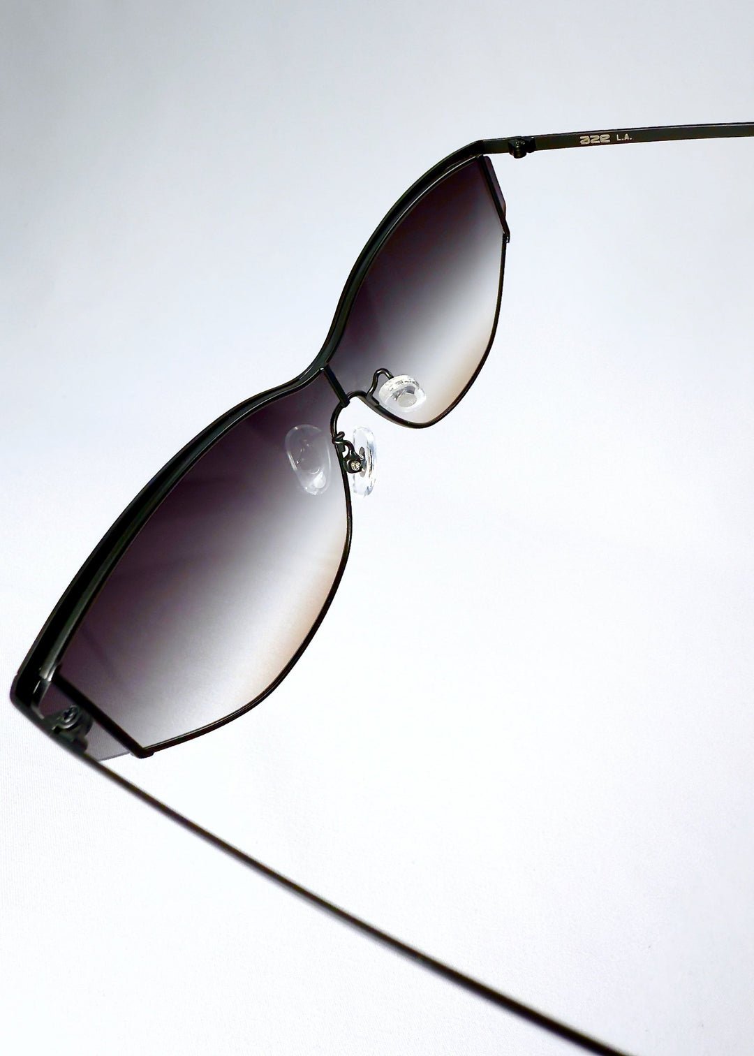 Inside view of Zenith sunglasses in Midnight Eclipse, showing the frame lines, adjustable nose pads and curved temples. 