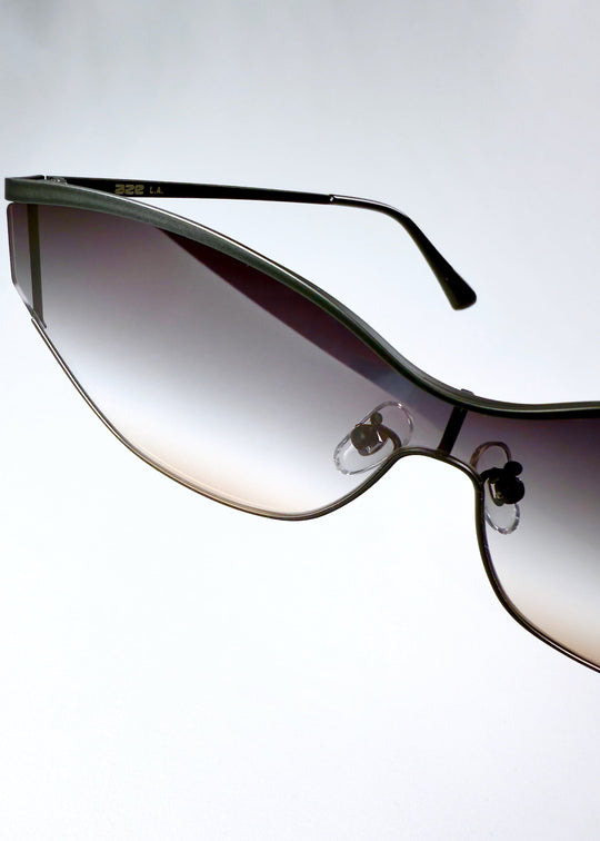 Close-up of Zenith sunglasses in Midnight Eclipse, showing the AZE logo, temple, lens edge and adjustable nose pad. 