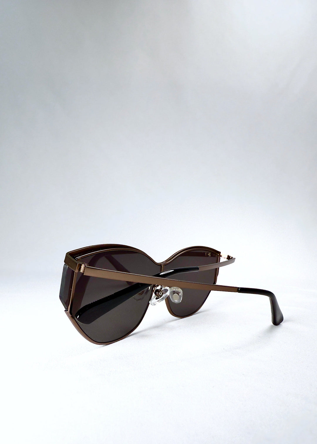 Folded view of Zenith sunglasses in Mocha Steel, showing the compact frame and hinge structure. 