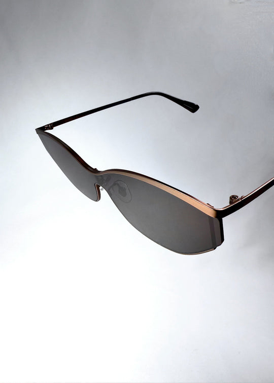 Close-up of Zenith sunglasses in Mocha Steel, highlighting the warm stainless-steel frame and shield lens edge. 