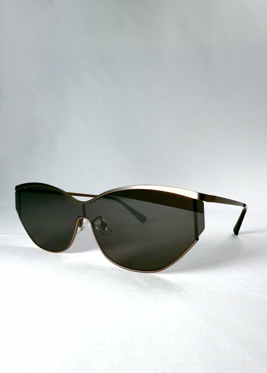 Three-quarter front view of Zenith sunglasses in Mocha Steel, highlighting the semi-rimless shield shape and warm metal finish. 