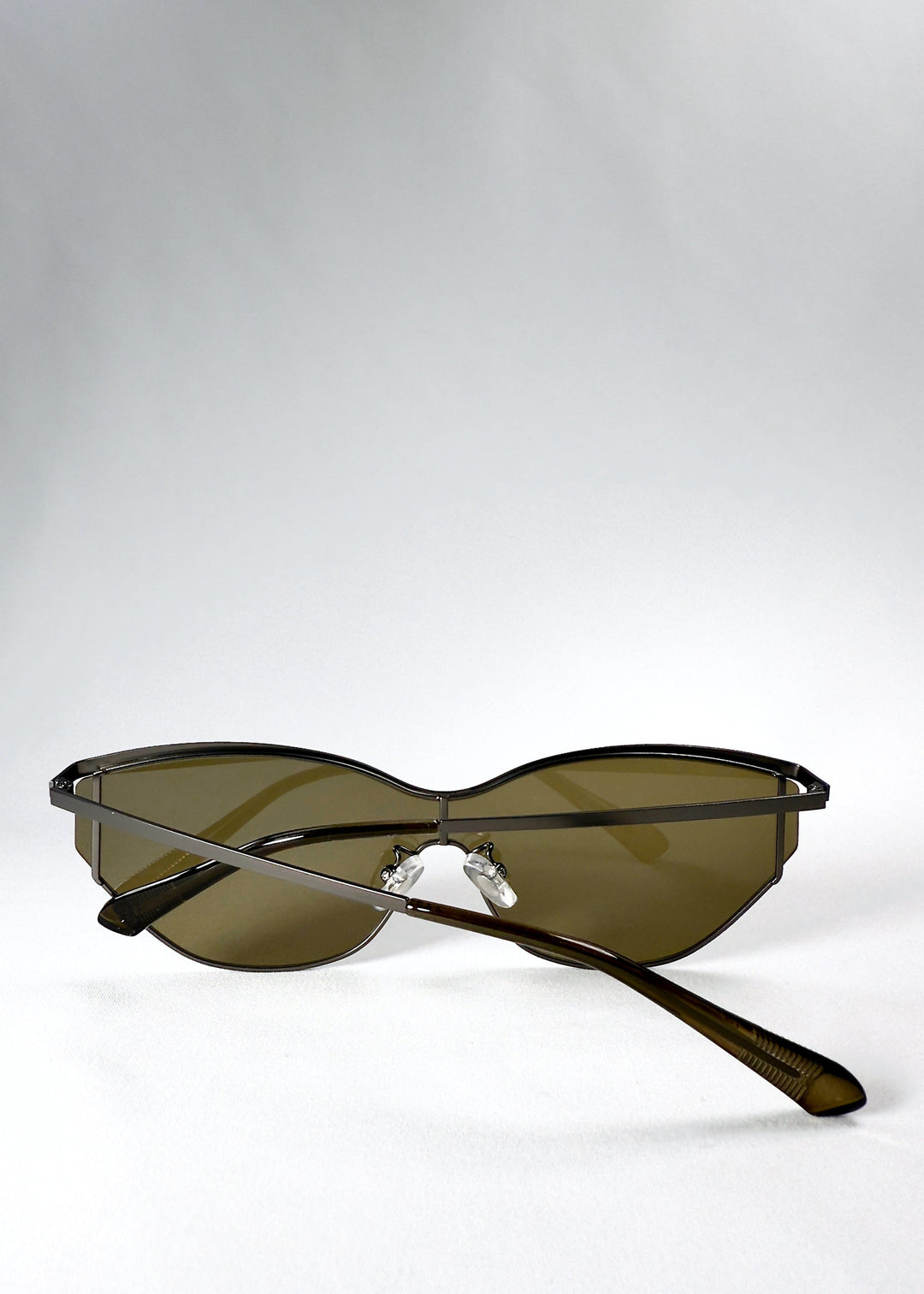 Folded view of Zenith sunglasses in Olive Smoke, showing the compact frame and curved lens profile. 