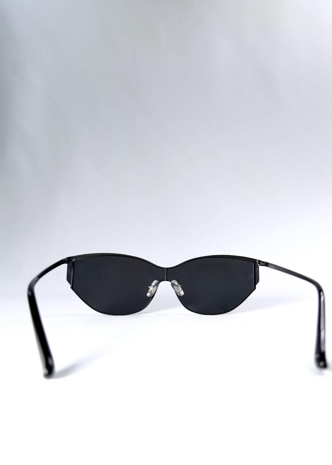 Back view of Zenith sunglasses in Onyx Black, showing the inner frame, adjustable nose pads and open temples. 