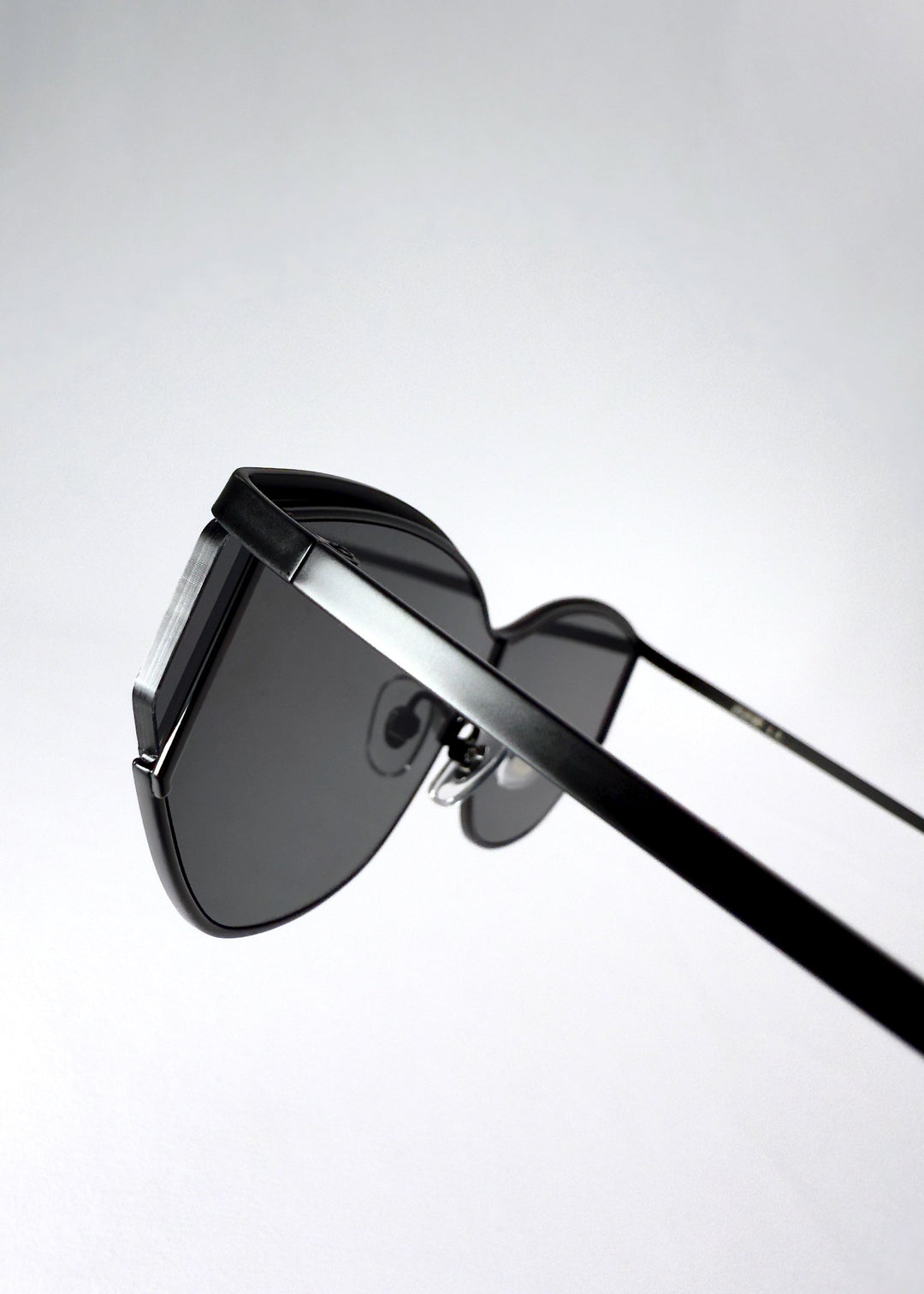 Angle detail of Zenith sunglasses in Onyx Black, highlighting the matte frame finish and shield lens edge. 
