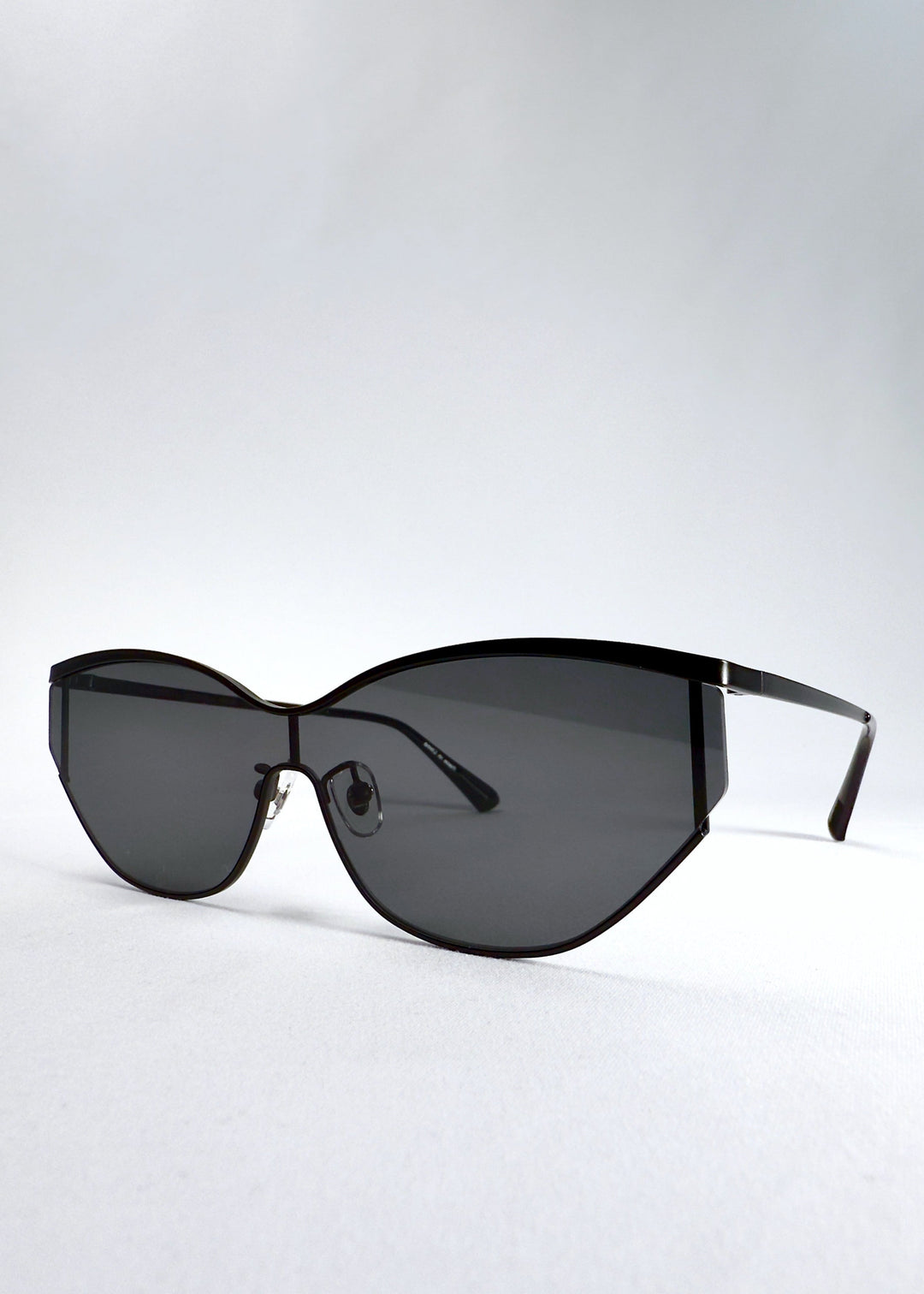 Three-quarter front view of Zenith sunglasses in Onyx Black, highlighting the matte black stainless-steel frame and dark lenses. 