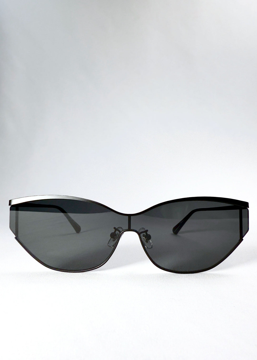 Front view of Zenith sunglasses in Onyx Black, showing the wide semi-rimless shield silhouette and dark gray HD nylon lenses. 