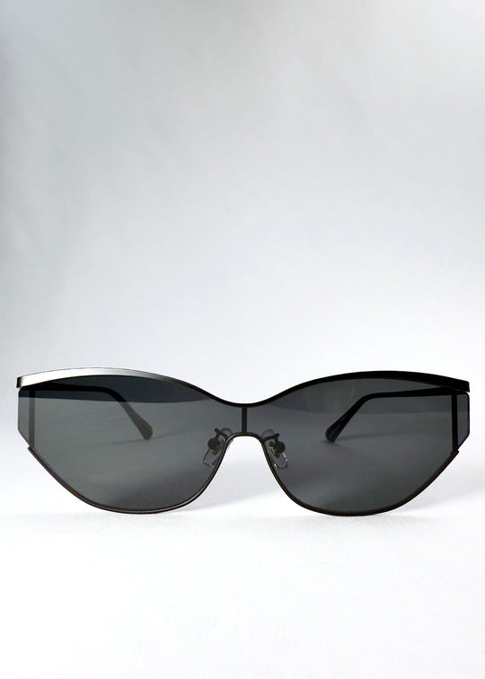 Front view of Zenith sunglasses in Onyx Black, showing the wide semi-rimless shield silhouette and dark gray HD nylon lenses. 